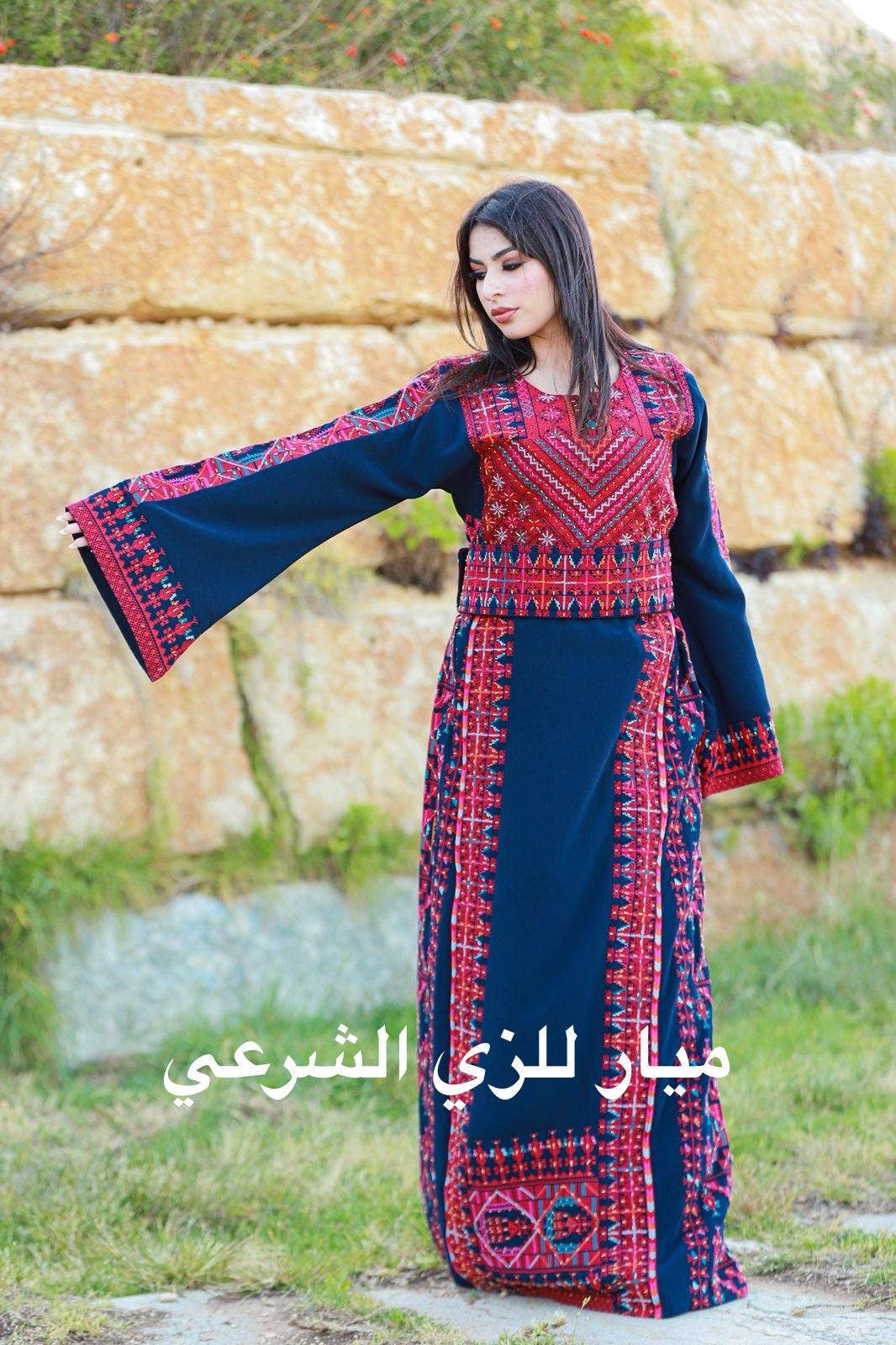 Navy blue thobe with red tatreez.