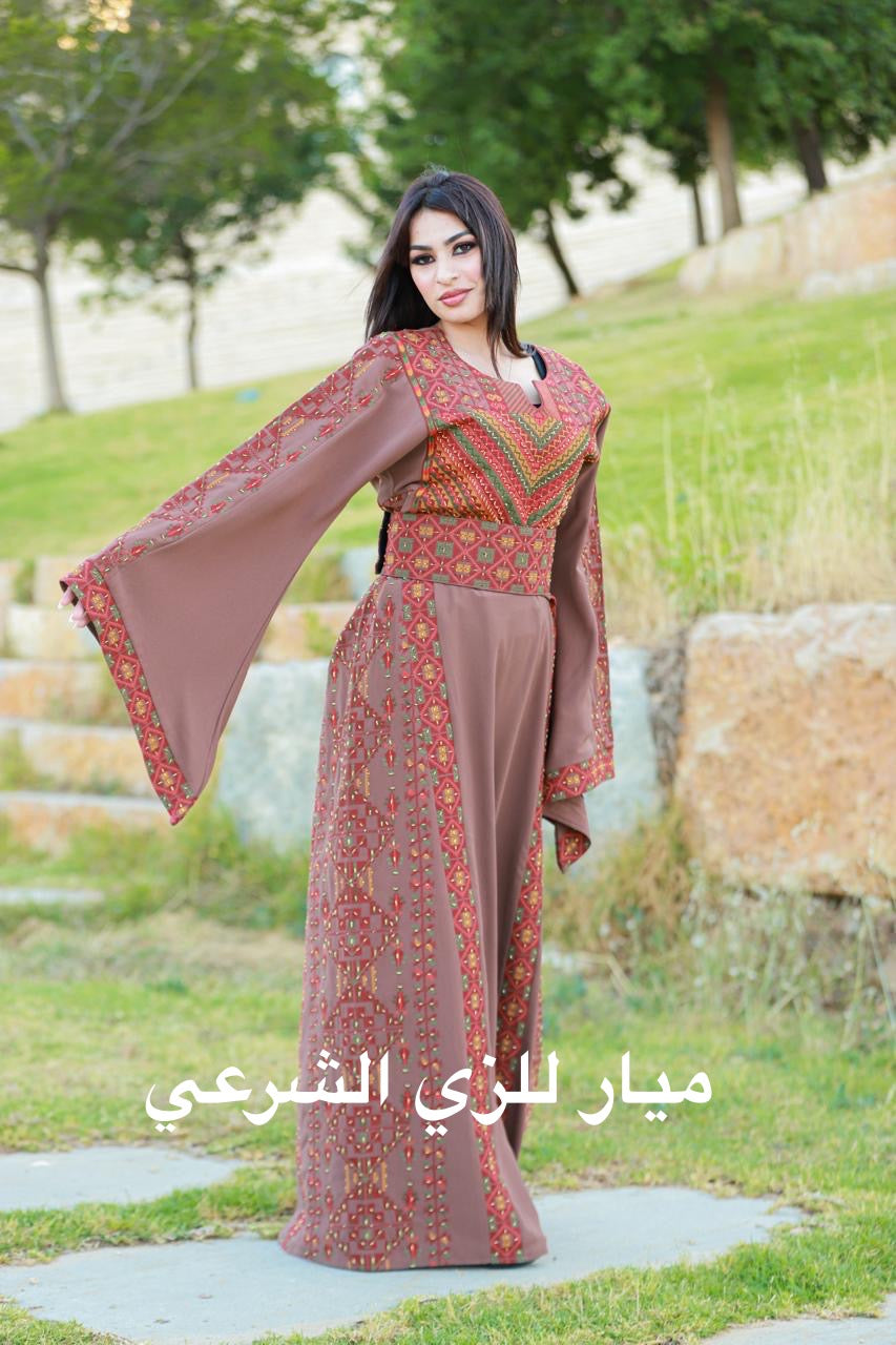 A beaded Pink nude base thobe with a multi colored tatreez.