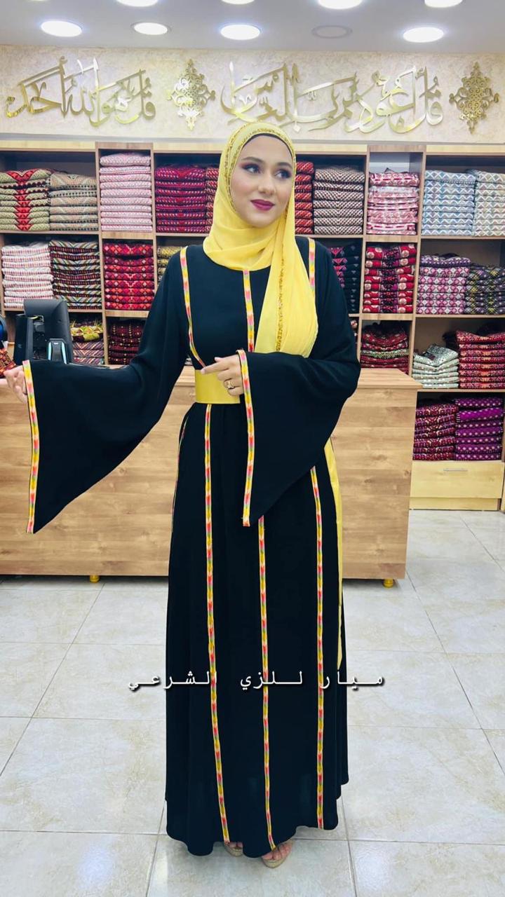 Black dress with yellow details and satin belt. Mayar Black dress with yellow details and satin belt. Mayar