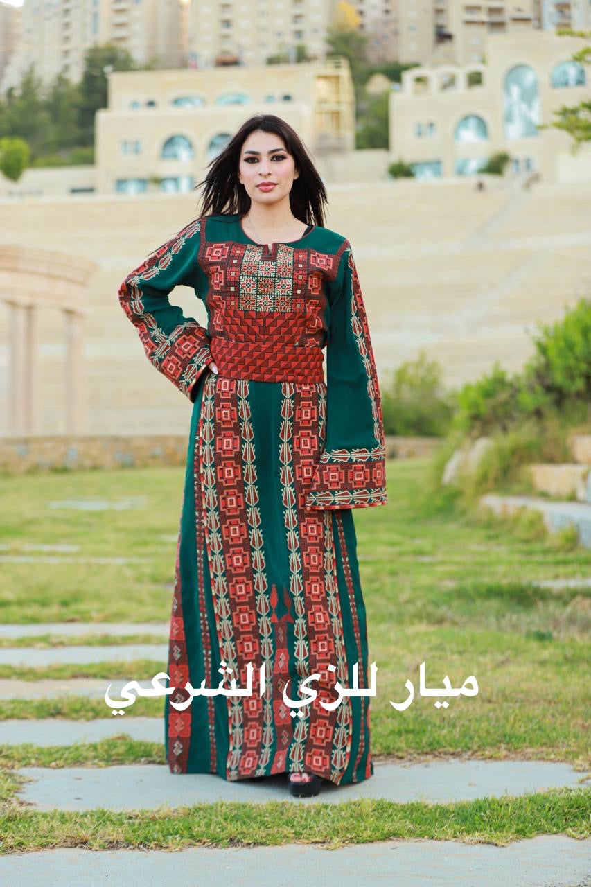 Green thobe with red and orange tatreez.