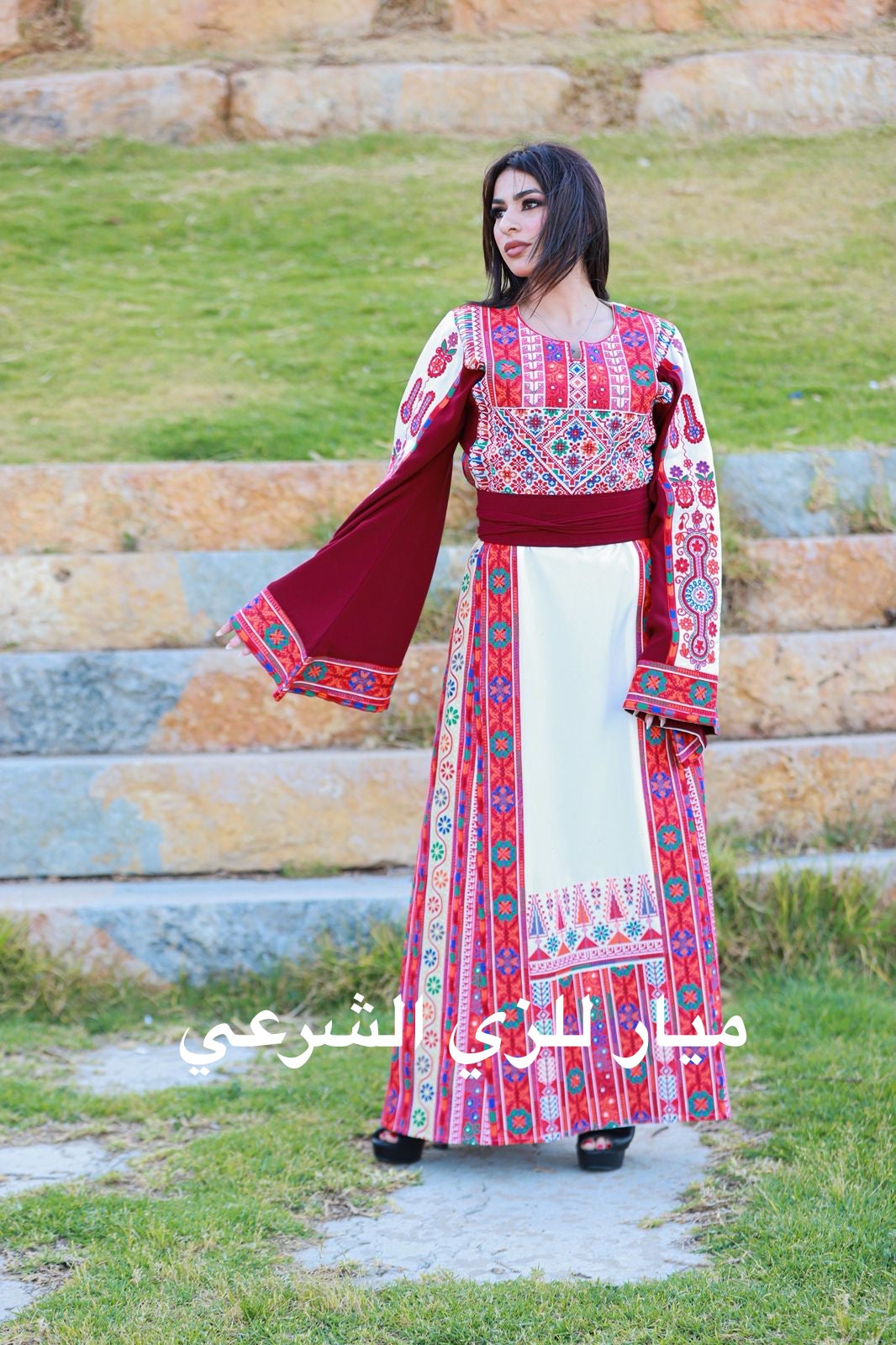 White thobe with red tones tatreez.