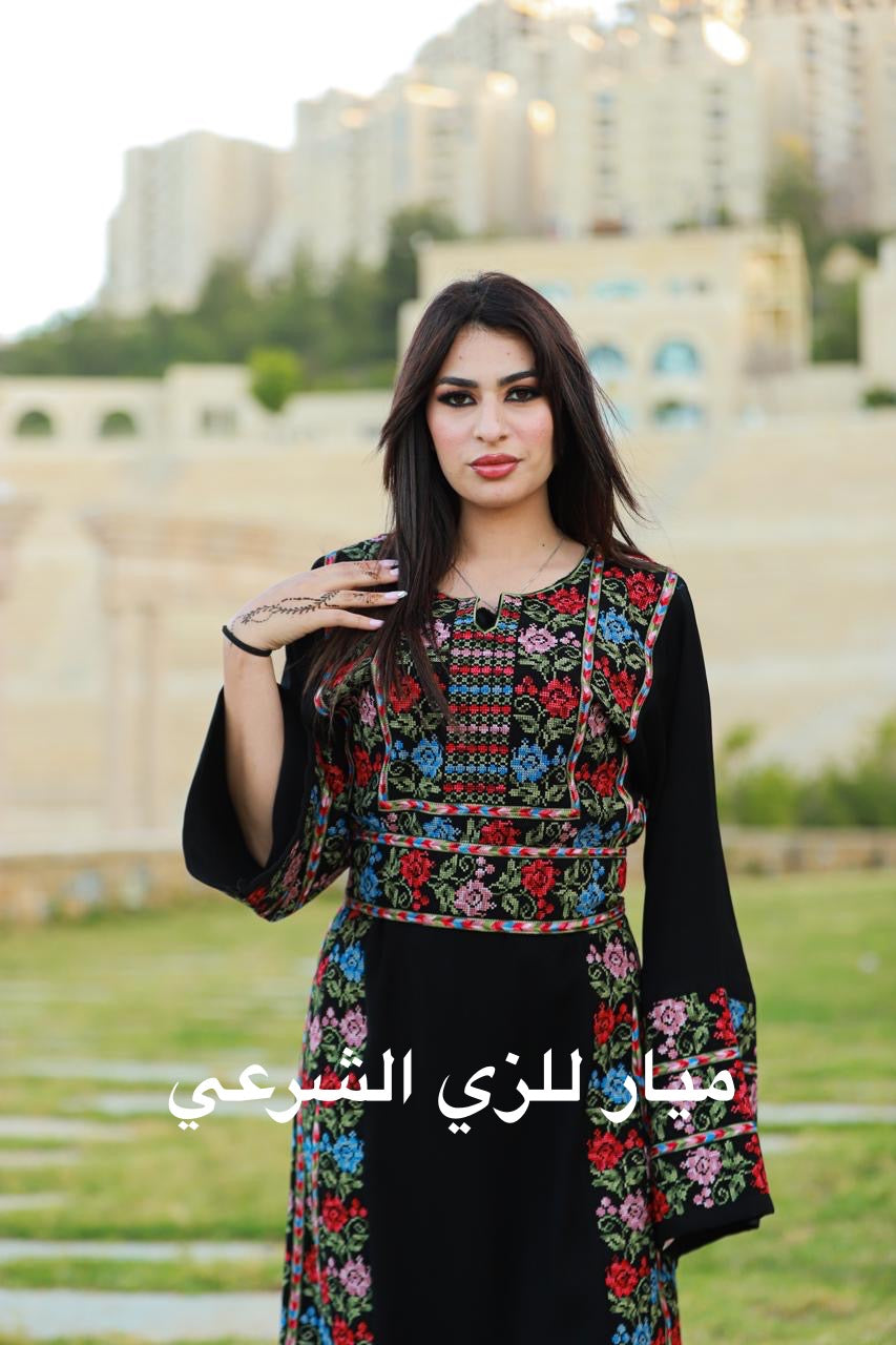 Black thobe with colorful tatreez details.