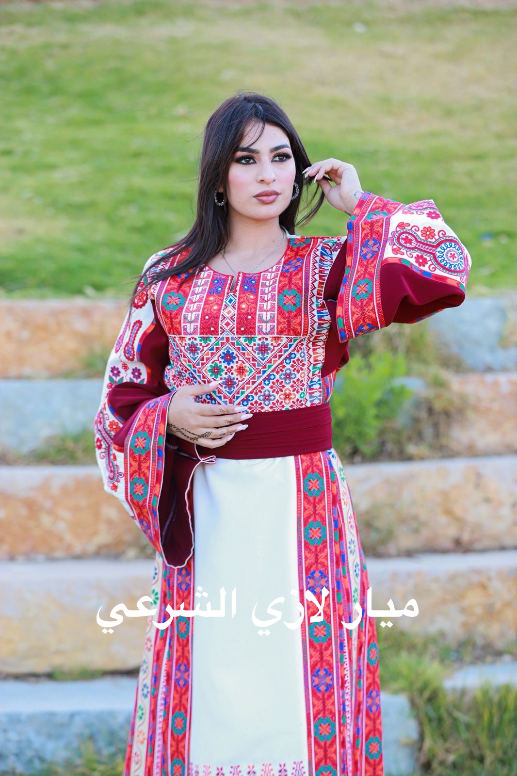 White thobe with red tones tatreez.