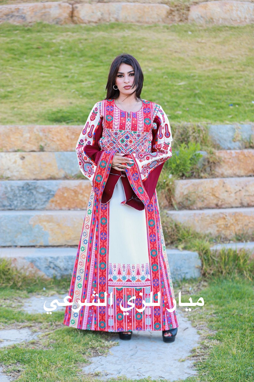 White thobe with red tones tatreez.