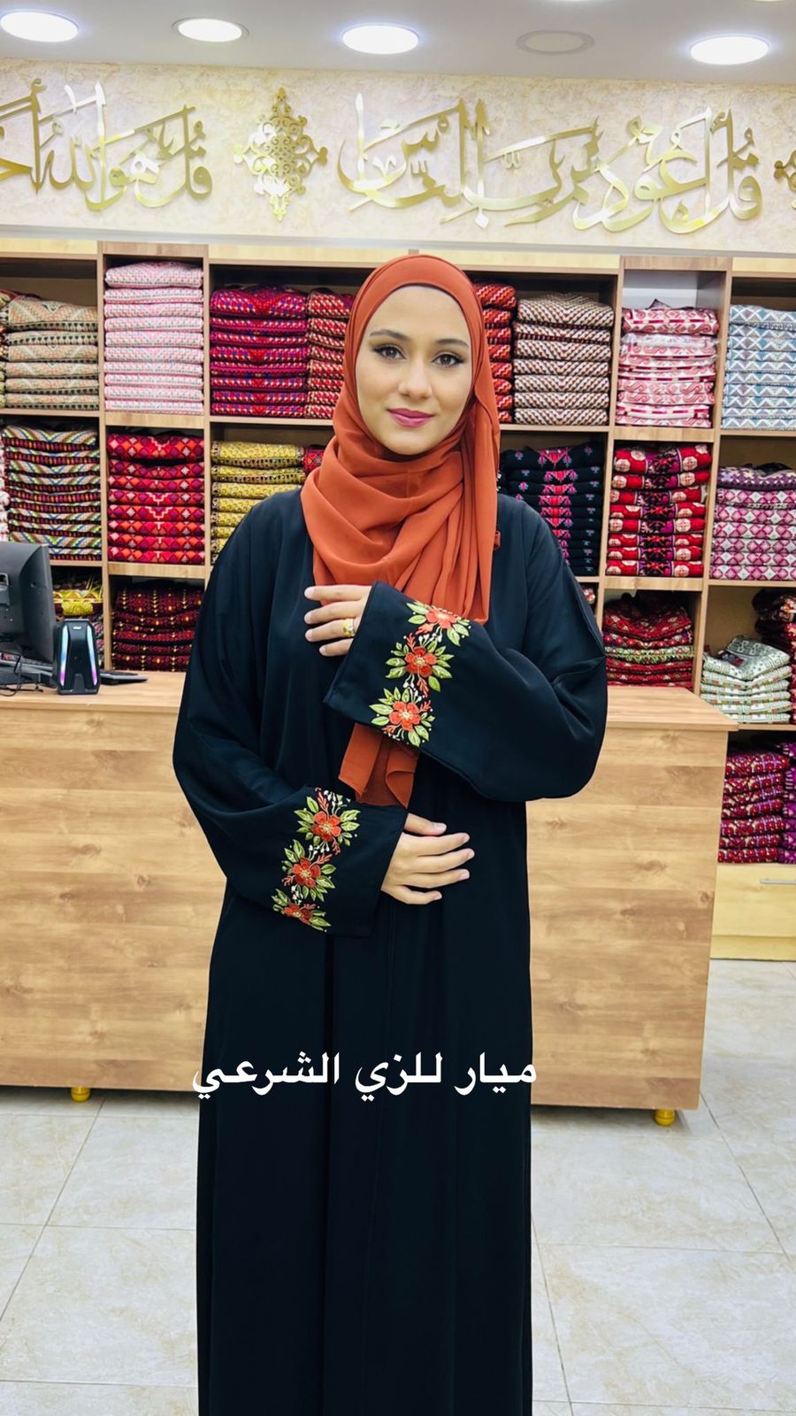 Black abaya with cute orange flowers details on the sleeve.