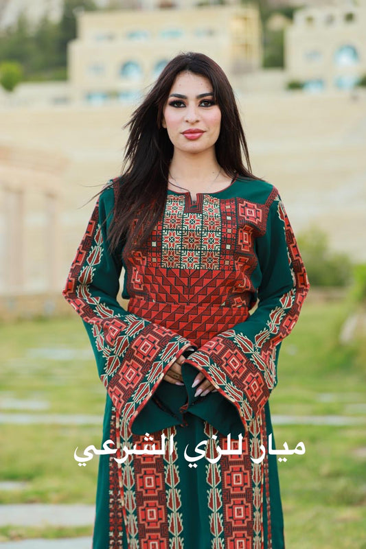 Green thobe with red and orange tatreez.