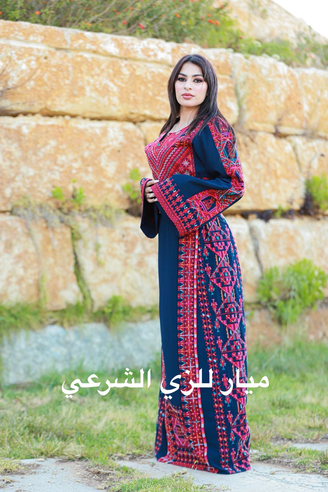 Navy blue thobe with red tatreez.