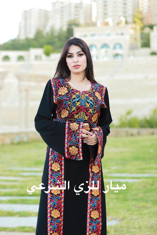 Black thobe with colorful tatreez details.