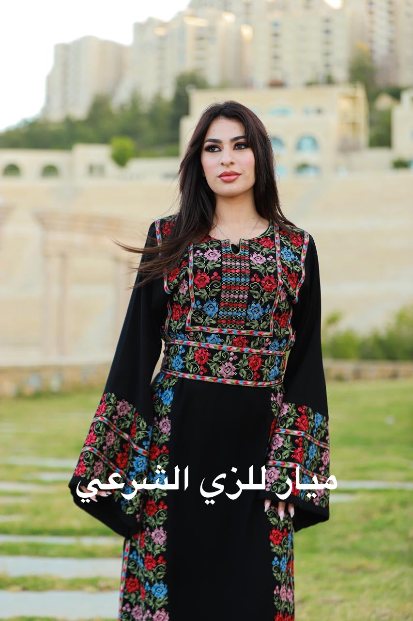 Black thobe with colorful tatreez details.