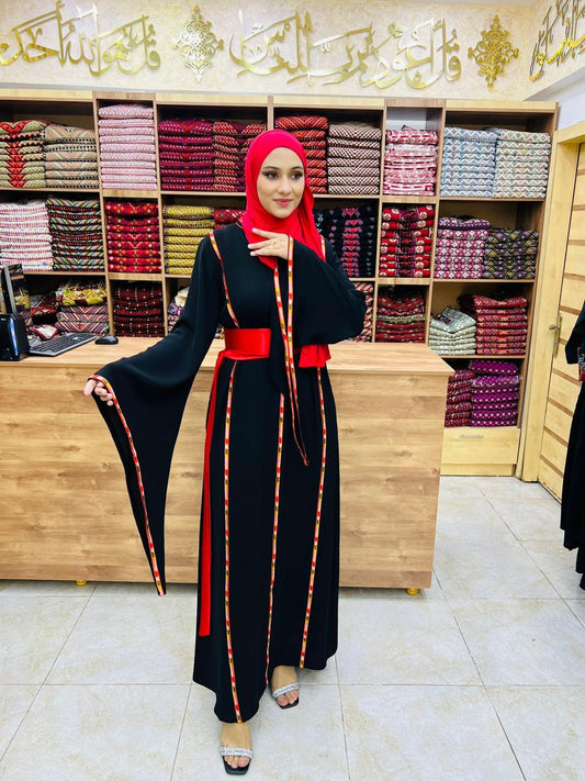 Black dress with red details and satin belt.